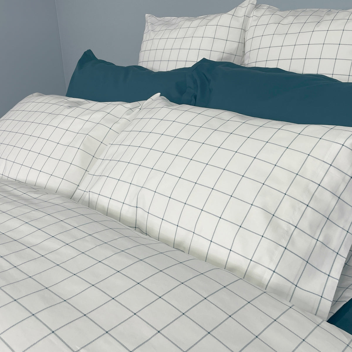 Tucker Duvet Cover in Deep Teal and Shams coordinated with Percale Deluxe in Deep Teal